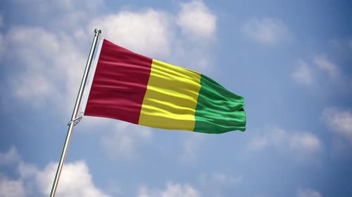 Guinea National Flag Waving Proudly Against Blue Sky