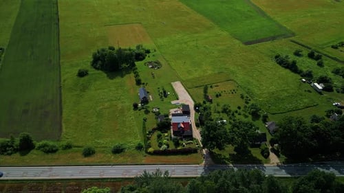 An Aerial View Showcasing Expansive Lush Green Fields Along with a Picturesque Country House Setting