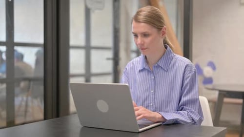 Woman with Headache Working on Laptop at Desk