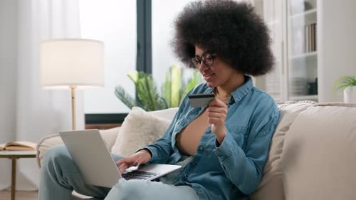 Woman Online Shopping with Credit Card on Laptop
