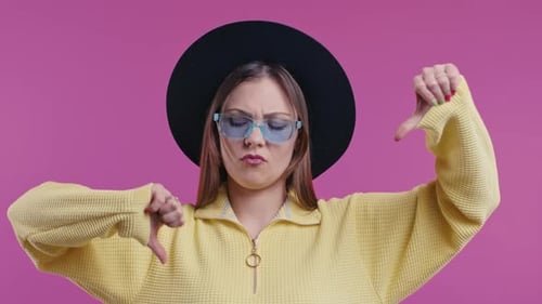Pretty Woman with Sign of Dislike Young Millennial Girl Showing Thumbsdown