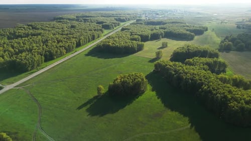 Summer Green Landscape with Field and Forest Aerial Flight Over a Forest and Farm Fields in