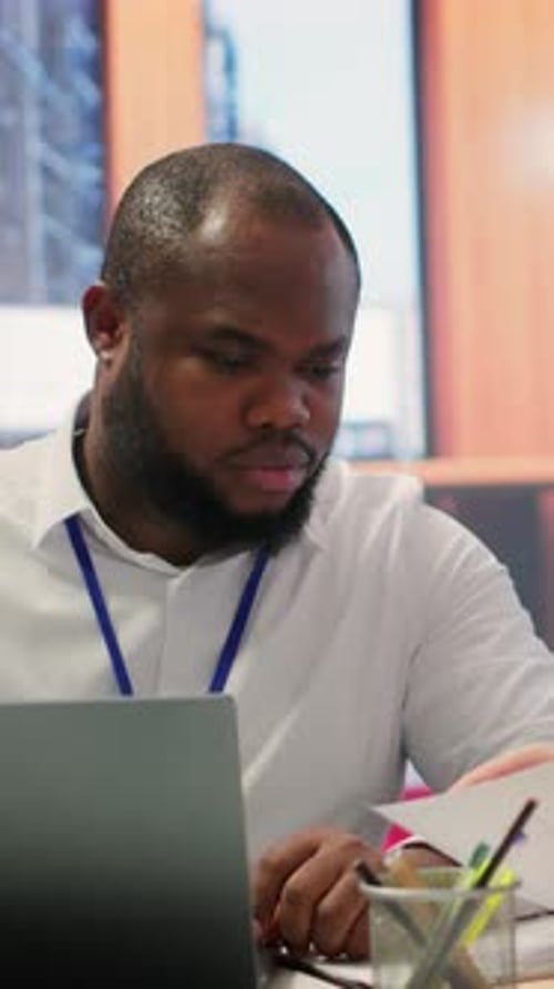 Man Working on Laptop in Technology Office