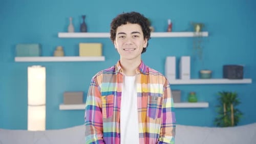 Young Adult Smiling Indoors With Curly Hair