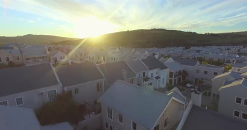 Real estate, houses in countryside with sunrise and drone, community in eco friendly development