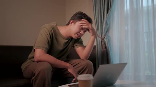 Young Adult Using Laptop at Home