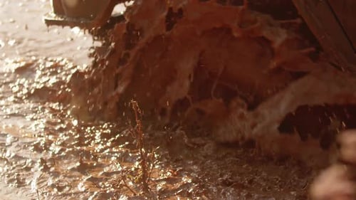 Huge Wheel of SUV Half Collapsed and Got Stuck in Deep Muddy Puddle and Slush Closeup