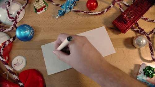 Hand Writes Holiday Card for Friend at Christmas