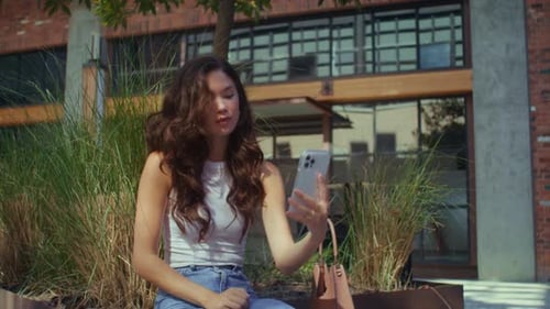 Joyful Dark Hair Woman Making Selfie on Bench Outdoors Close Up. Awesome