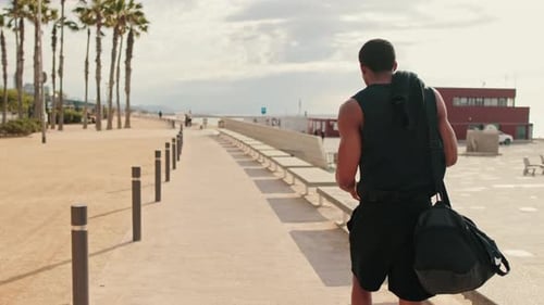 Man Walking to Workout on Beach Promenade