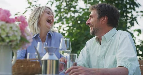 Loving Couple Celebrating Outdoor with Wine and Affection