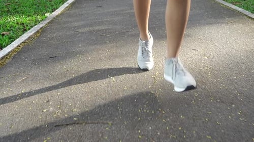 Get an up-close look at a runner's footwear with this detailed close-up footage of a man jogging on