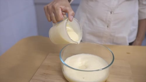 woman serving condensed milk on a bowl 120 fps