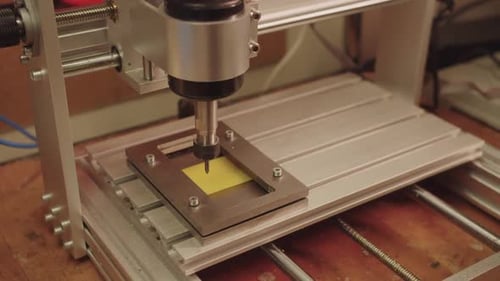 A Machine is Making a Hole in a Piece of Paper