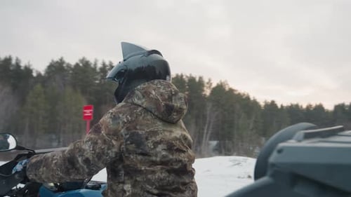 ATV Rider Preparations Rider Gets Ready for Winter Adventure Operator Suited Up with Protective Gear