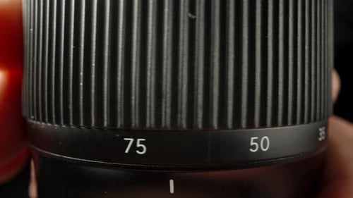 Close-up of the camera lens, I rotate the zoom ring from 28 to 75 millimeters