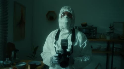 Portrait of Forensic Photographer in Protective Uniform Posing with Camera