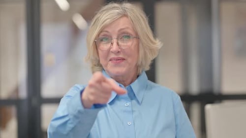 Smiling Woman Points at the Camera