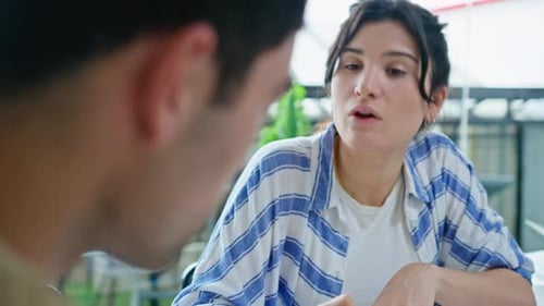 Young Businesswoman Discussing Plans with Colleague in the Office