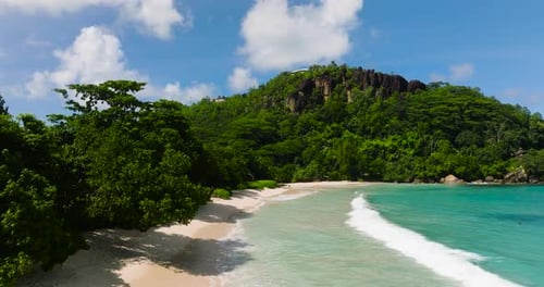 Waves Meeting Sandy Shore with Distant Hillside View Seychelles Mahe