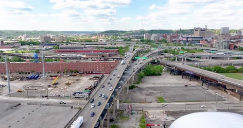 Aerial view of a highway interchange and urban skyline, United States.