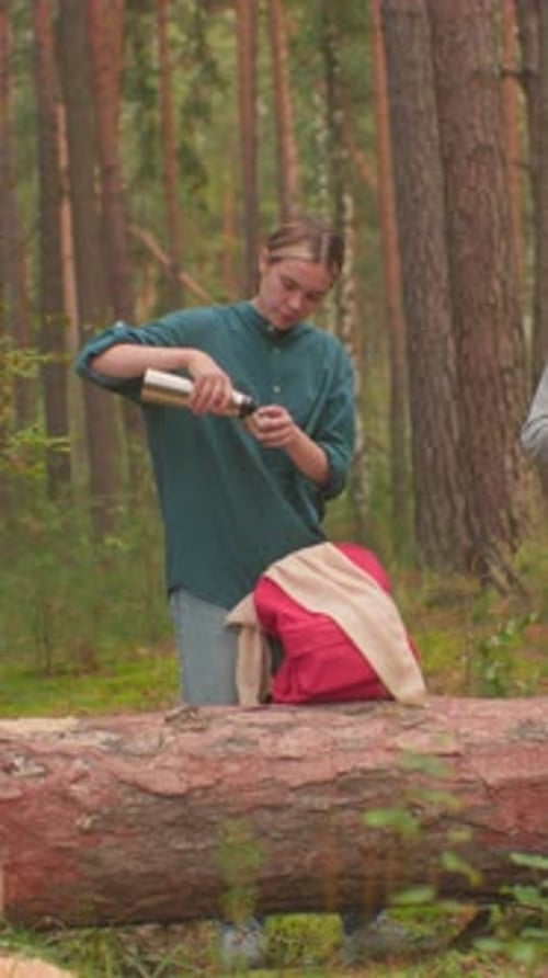 Hikers Refresh with Water and Haircare in Peaceful Forest