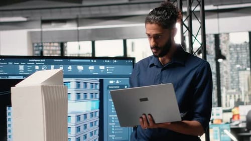 Architect Working on Laptop in Modern Office