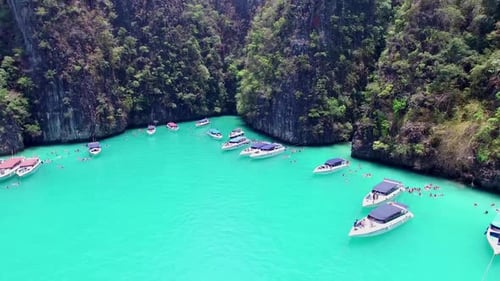 Aerial view of iconic tropical turquoise water Pileh Lagoon surrounded by limestone cliffs, Phi Phi