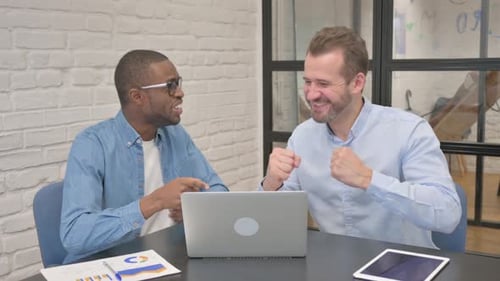 Excited Business People Celebrating Success in Office