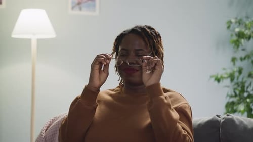 Woman Smiling After Taking Off Glasses Indoors