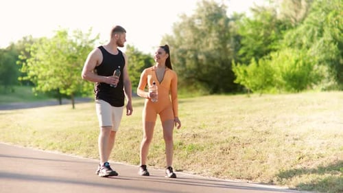 Athletic Couple Walking Together in Green Park
