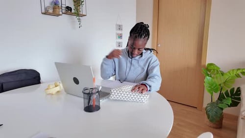 Young Woman Studying and Taking Notes at Home