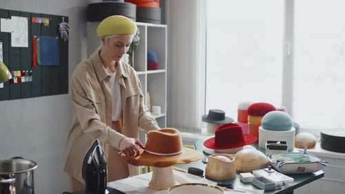 Woman Crafts Tan Hat in her Studio