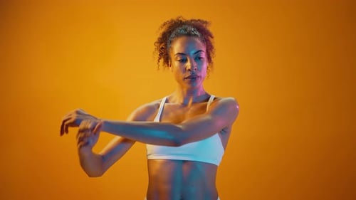 Woman Stretching Arms in Athletic Wear
