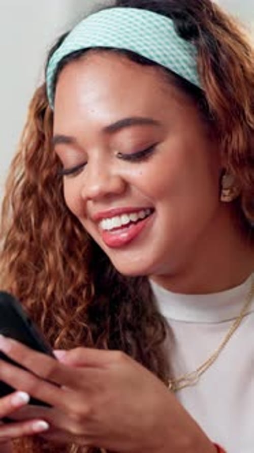 Smiling Young Woman Uses Smartphone