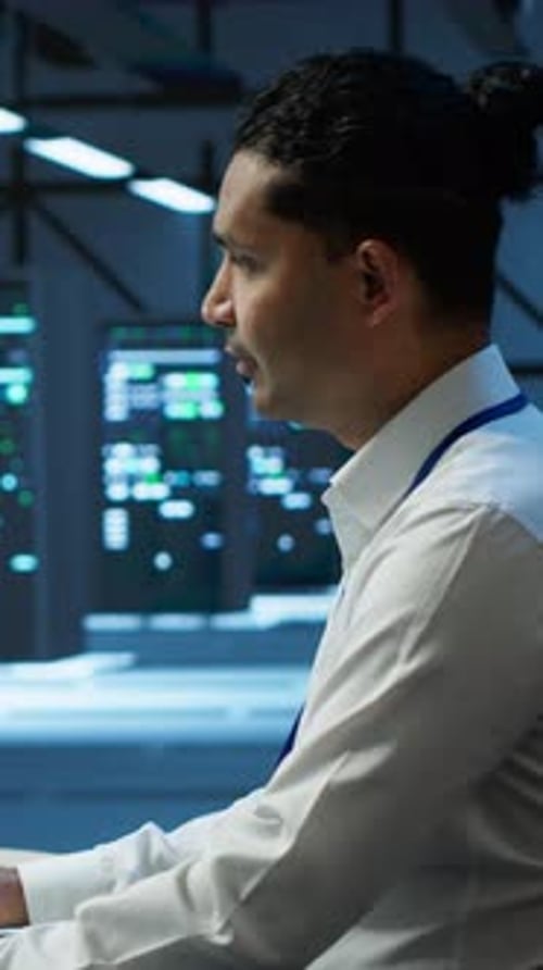 Vertical Video Portrait of Upbeat Admin in Data Center Managing Servers