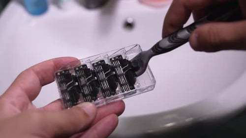 Gillette Mach 3 shaver and four blocks of spare cassettes for it on top view.