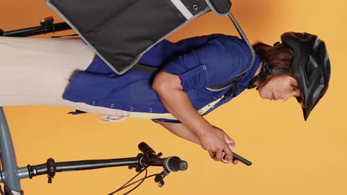 Woman with Bicycle Typing on Phone