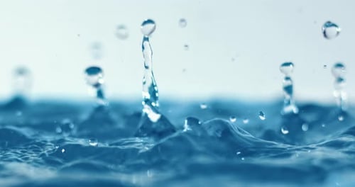 Splashing Water Droplets on Blue Surface