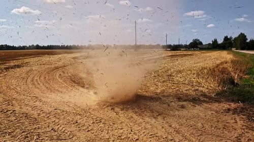 Wind swirls and blows sand into a mini twister or dust devil