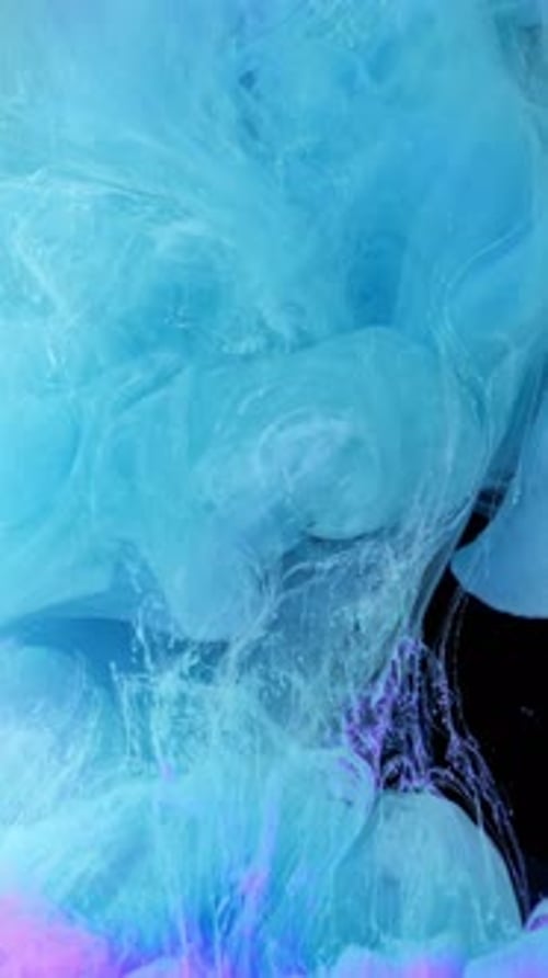 Blue and Pink Ink Swirling Abstractly in Water