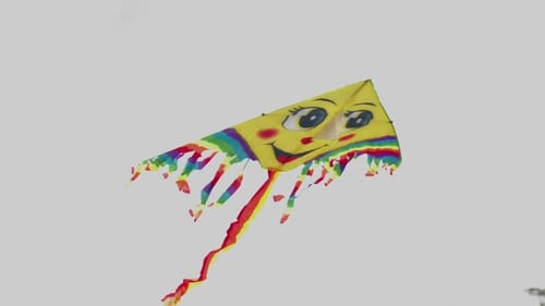 Whimsical Kite with Smiling Face Floats in Sky