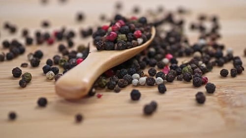 Close Up of Peppercorns in Wooden Spoon