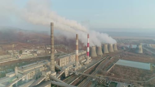 Aerial Drone View of Tall Chimney Pipes with Grey Smoke From Coal Power Plant Production of