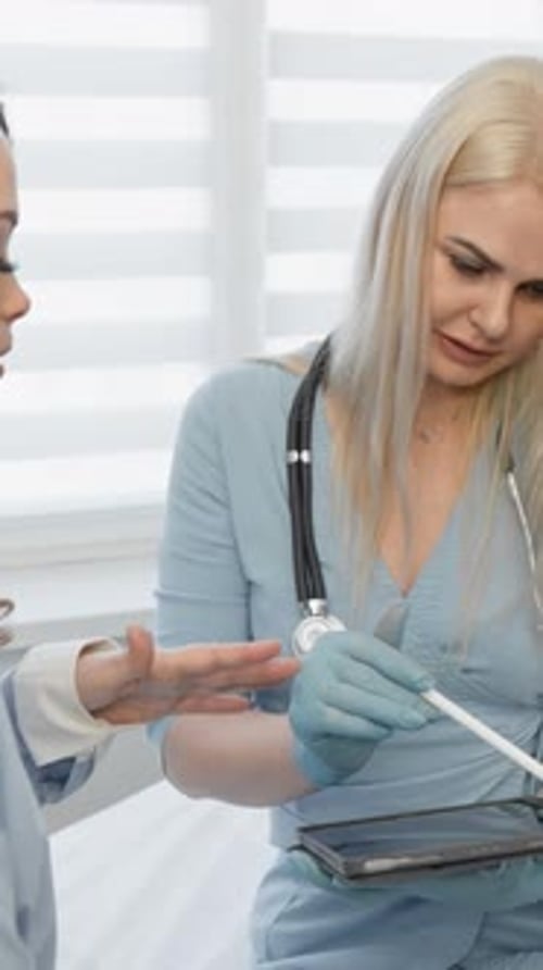 Doctor Reviews Information with Patient on Tablet