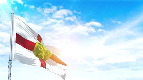 Guernsey Flag Waving Against Blue Sky with Sunlight and Clouds