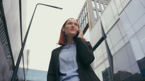 Business Woman Talking on Mobile Phone in City