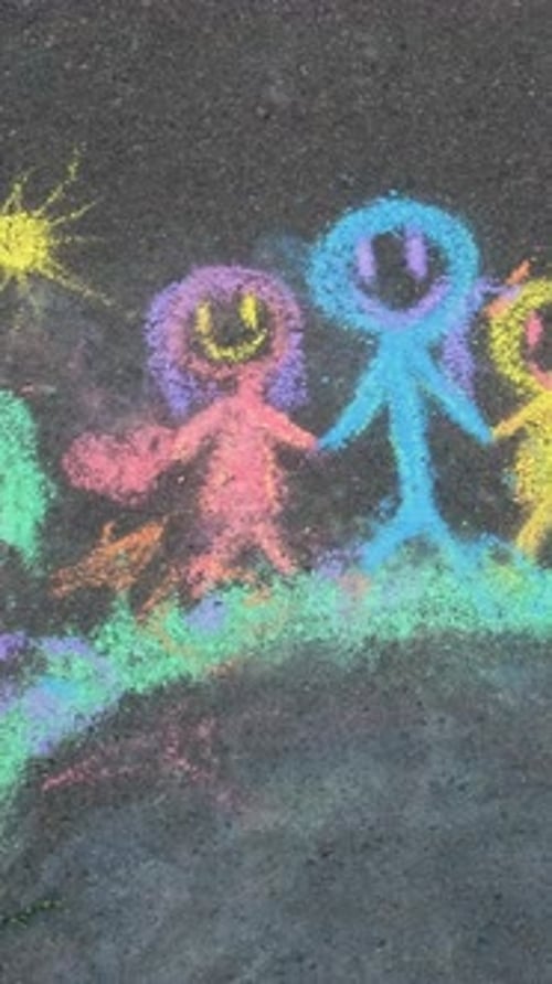 Children Drawing with Chalk on the Asphalt Selective Focus