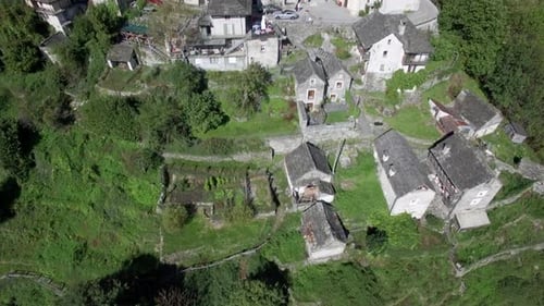 revealing aerial shot of medieval town village of Corippo in the mountains, small mountain village i