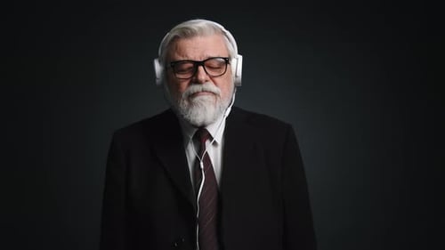 Elegant Senior Man Listening with Headphones